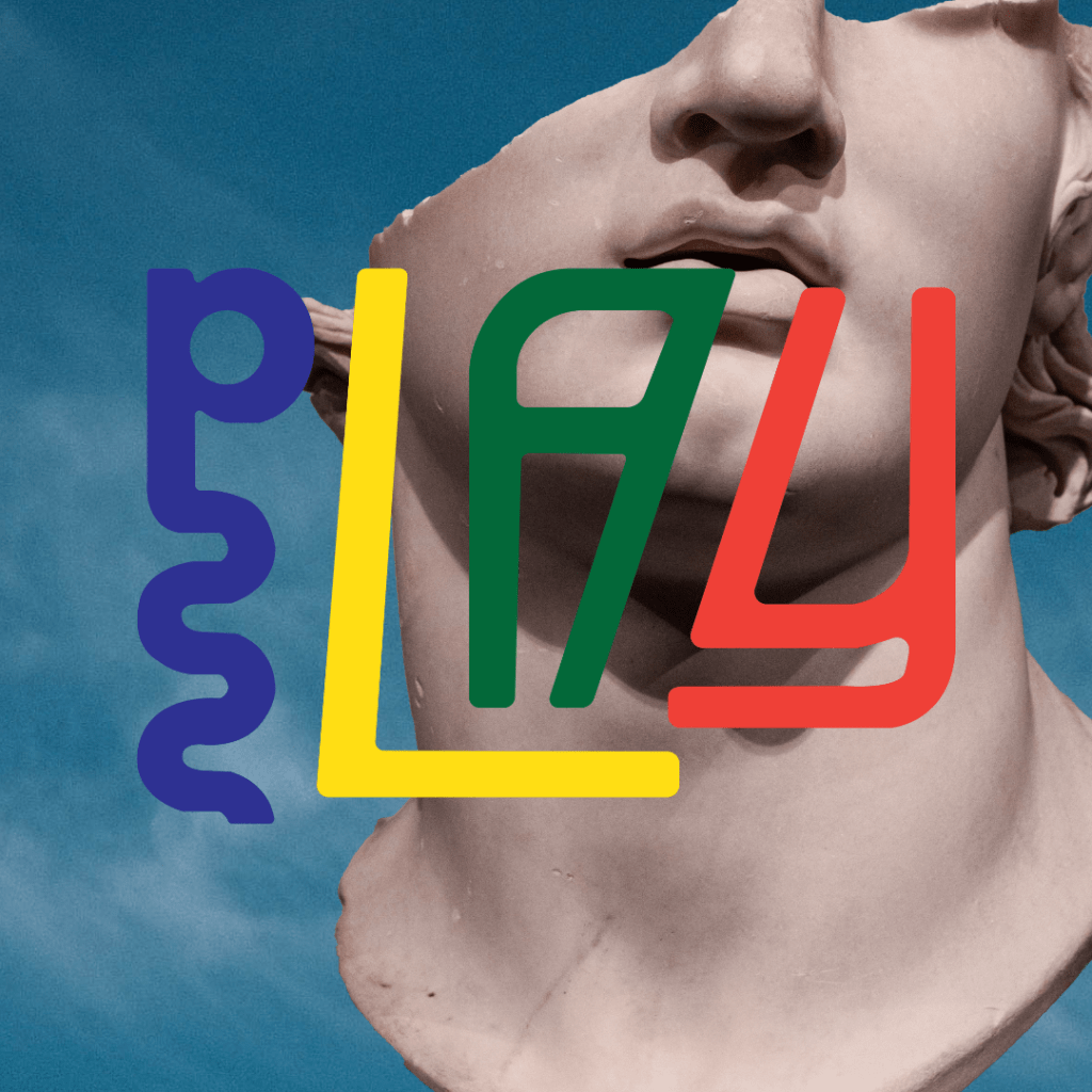 Half of the face of a carved grey sculpture sits behind the colourful PLAY logo